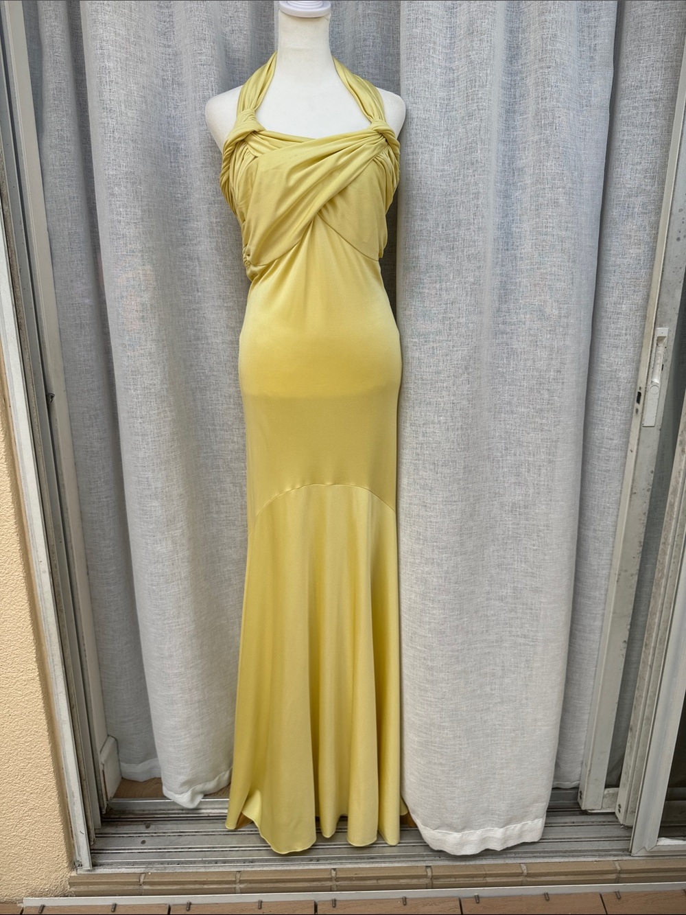 Light yellow halter silk maxi dress gown with a twist-front bodice flared hem